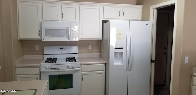 kitchen featuring white cabinetry and white appliances