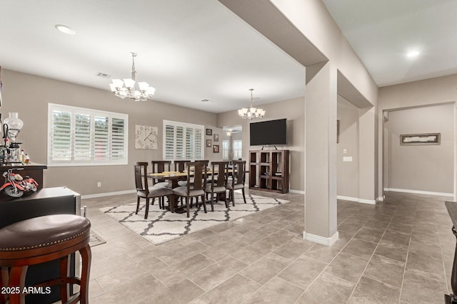 dining room featuring an inviting chandelier and plenty of natural light