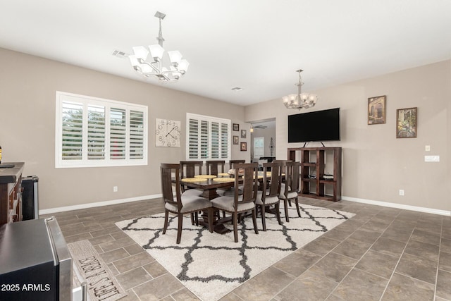 dining space with an inviting chandelier