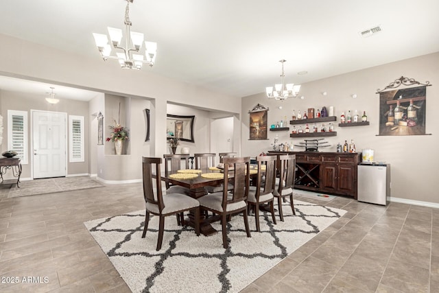 dining space featuring indoor bar and a chandelier