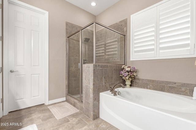 bathroom featuring separate shower and tub