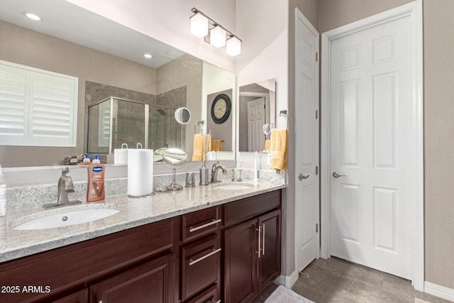 bathroom with vanity and a shower with shower door