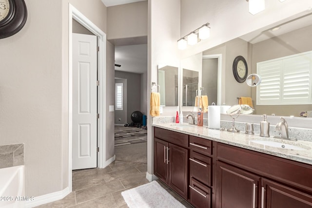 bathroom with tile patterned floors, vanity, and a tub