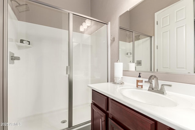 bathroom featuring vanity and a shower with shower door