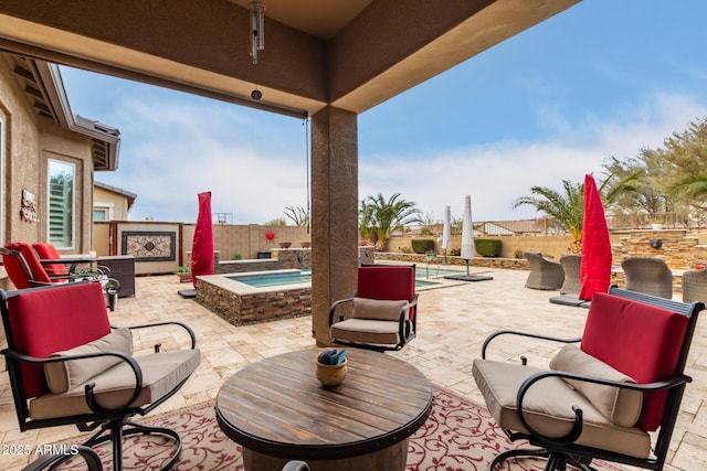 view of patio / terrace featuring a swimming pool with hot tub