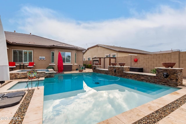 view of swimming pool with an in ground hot tub