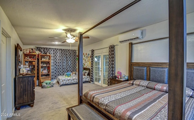 bedroom featuring a wall mounted air conditioner, french doors, carpet flooring, ceiling fan, and a textured ceiling