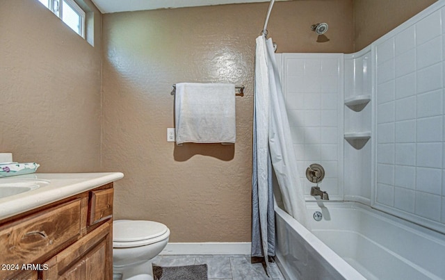 full bathroom featuring tile patterned floors, vanity, shower / tub combo, and toilet