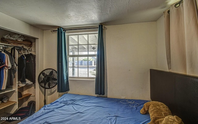 bedroom with a closet and a textured ceiling