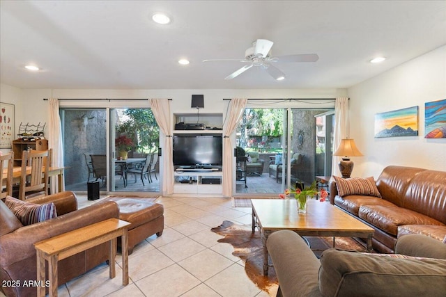 living area with light tile patterned floors, recessed lighting, and a ceiling fan