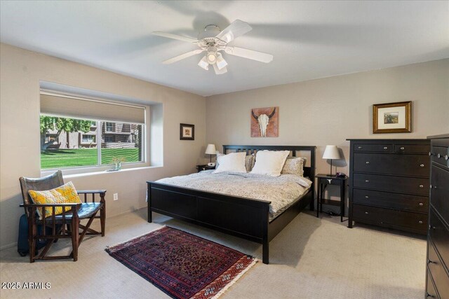 bedroom featuring light carpet, baseboards, and a ceiling fan