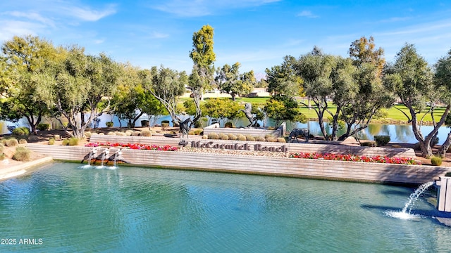 view of pool featuring a water view