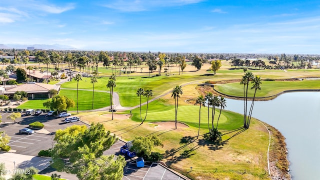 birds eye view of property with a water view and view of golf course