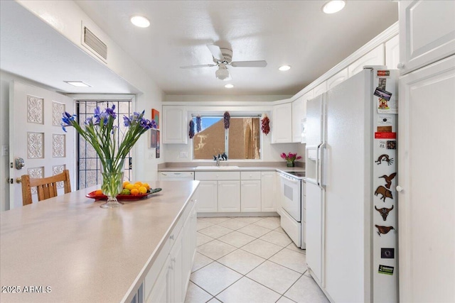 kitchen featuring a sink, white appliances, white cabinets, and a ceiling fan