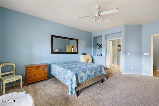 carpeted bedroom featuring ceiling fan and baseboards