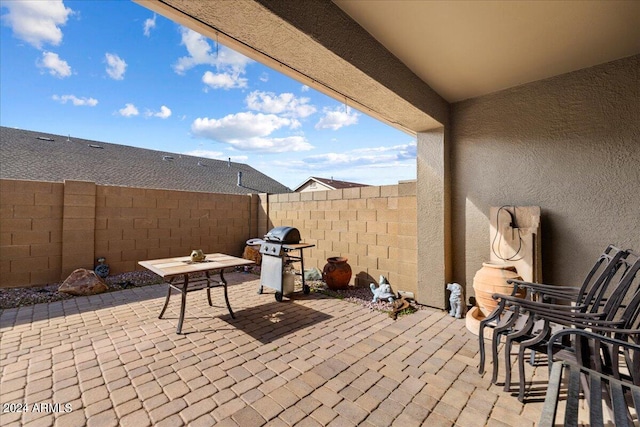 view of patio / terrace with area for grilling and a fenced backyard