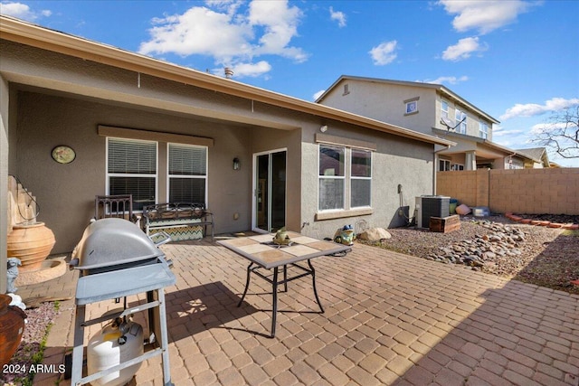 back of property featuring stucco siding, a patio, fence, and central air condition unit