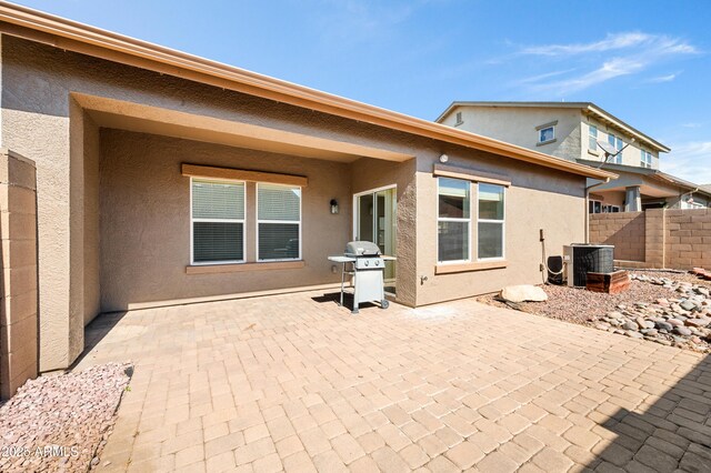 back of house featuring cooling unit, a patio, fence, and stucco siding