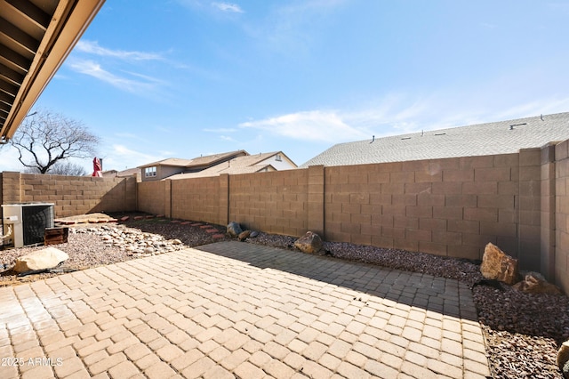view of patio featuring cooling unit and a fenced backyard