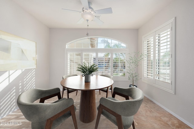 dining space with ceiling fan and light tile patterned floors