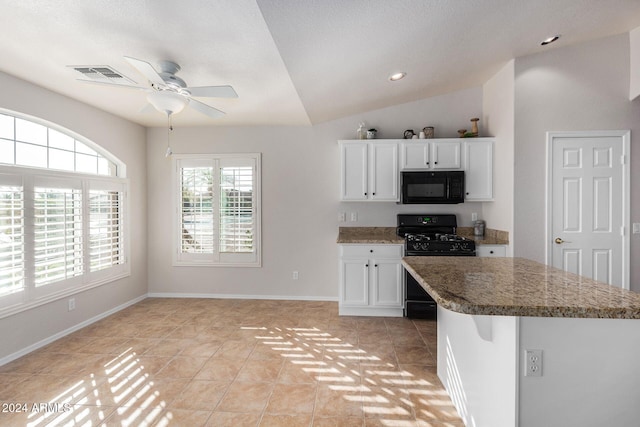 kitchen with light stone counters, vaulted ceiling, black appliances, light tile patterned floors, and white cabinets