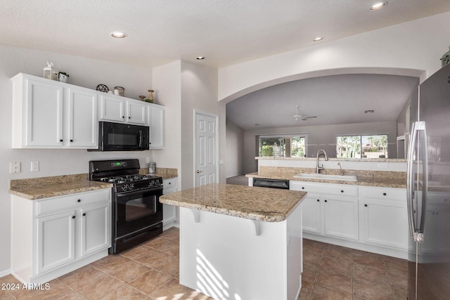 kitchen featuring a center island, black appliances, sink, white cabinetry, and kitchen peninsula