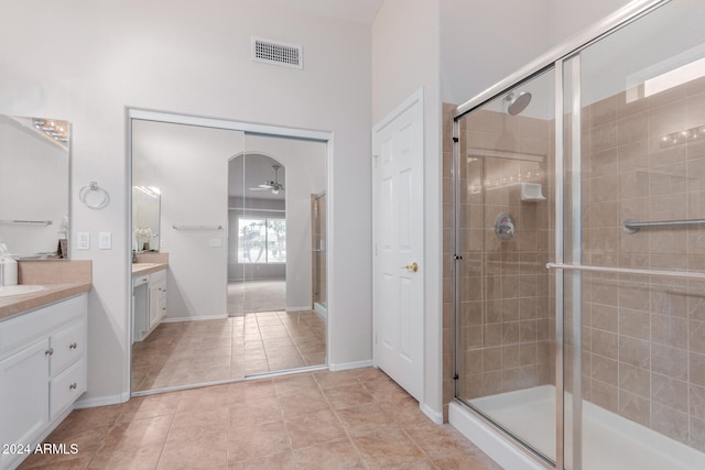 bathroom with vanity, tile patterned floors, a shower with door, and ceiling fan