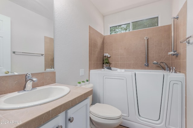 bathroom with a tub to relax in, vanity, and toilet