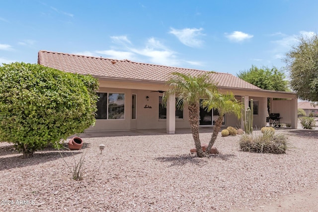 3582 N 160th Ave, Goodyear, AZ 85395 - back of property with a tiled roof, a patio area, and stucco siding