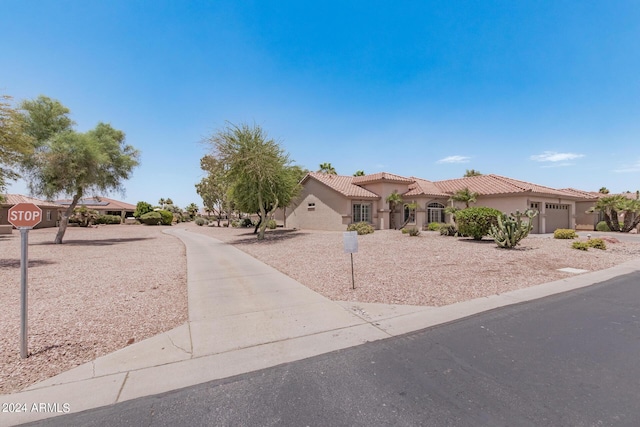 3582 N 160th Ave, Goodyear, AZ 85395 - mediterranean / spanish-style home with a garage, stucco siding, a tile roof, and driveway