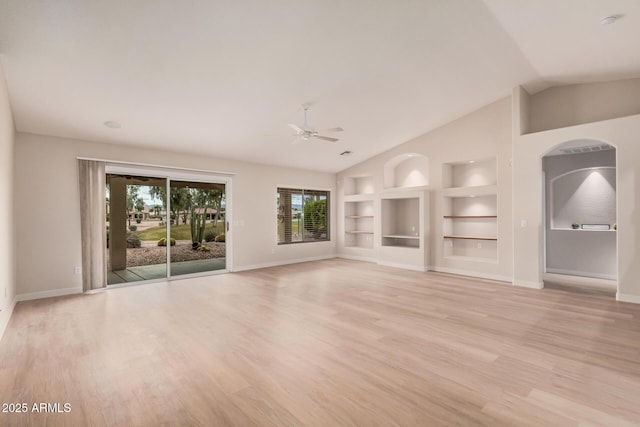 3582 N 160th Ave, Goodyear, AZ 85395 - unfurnished living room featuring built in features, ceiling fan, baseboards, and vaulted ceiling