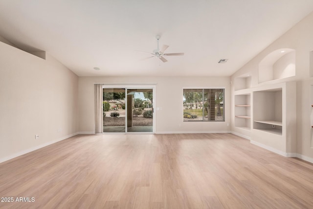 3582 N 160th Ave, Goodyear, AZ 85395 - unfurnished living room featuring ceiling fan, built in shelves, light wood-style flooring, baseboards, and vaulted ceiling