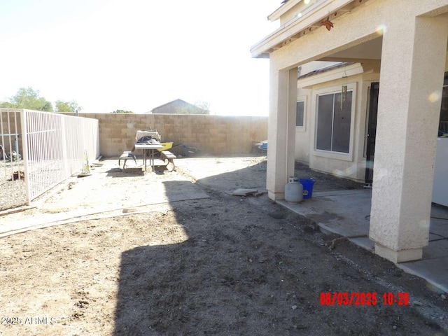 view of yard featuring a patio area and a fenced backyard