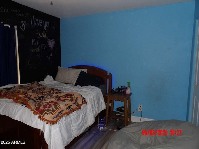 bedroom featuring wood finished floors