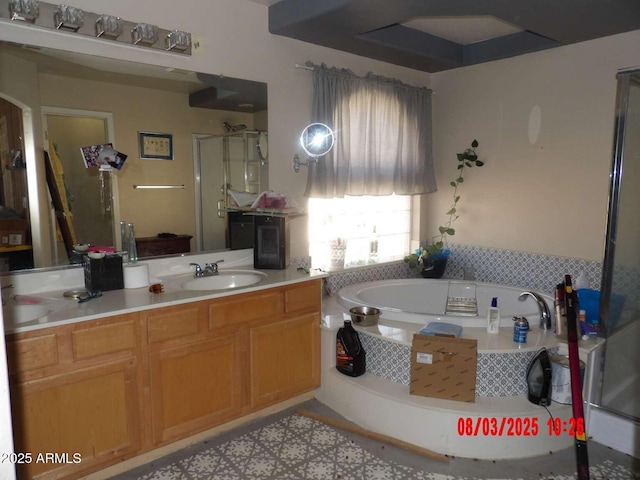 bathroom featuring vanity, a bath, and a shower stall