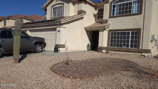 view of property exterior featuring stucco siding, an attached garage, and a tile roof