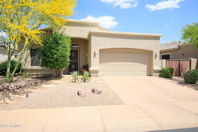5014 E Kirkland Rd, Phoenix, AZ 85054 - view of front of property featuring stucco siding, a garage, concrete driveway, and fence
