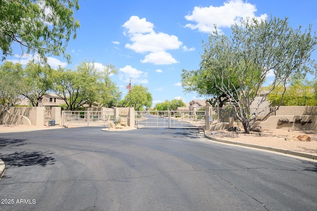 5014 E Kirkland Rd, Phoenix, AZ 85054 - view of asphalt road featuring a gate, a gated entry, and curbs