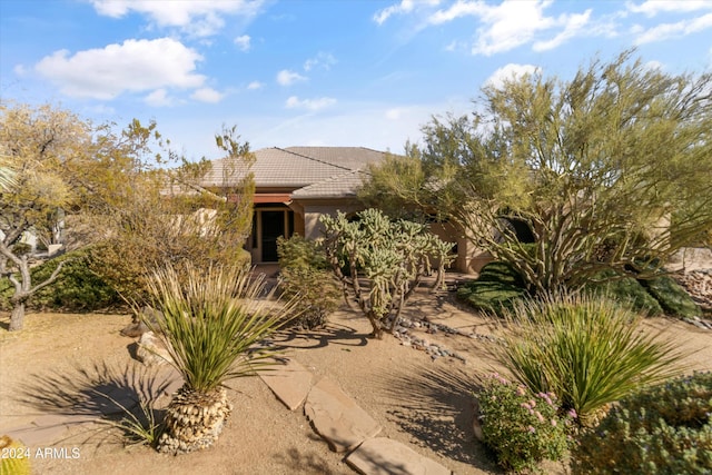 view of front of home featuring stucco siding and a tiled roof