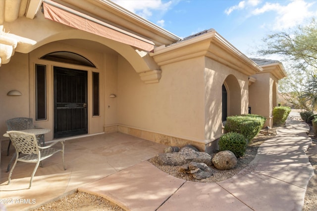 doorway to property featuring a patio