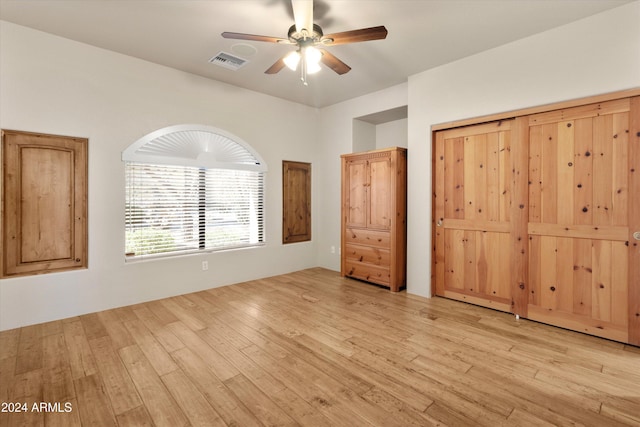 unfurnished bedroom with a closet, ceiling fan, and light hardwood / wood-style flooring