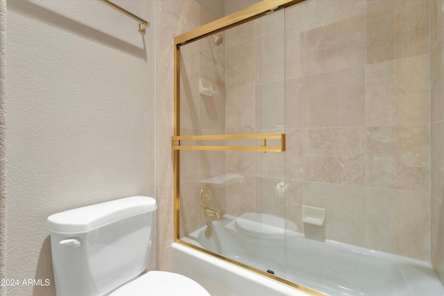 bathroom featuring toilet and enclosed tub / shower combo