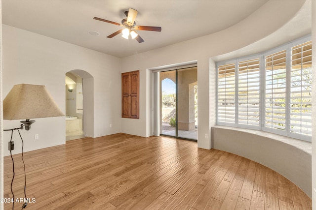 empty room with hardwood / wood-style flooring and ceiling fan