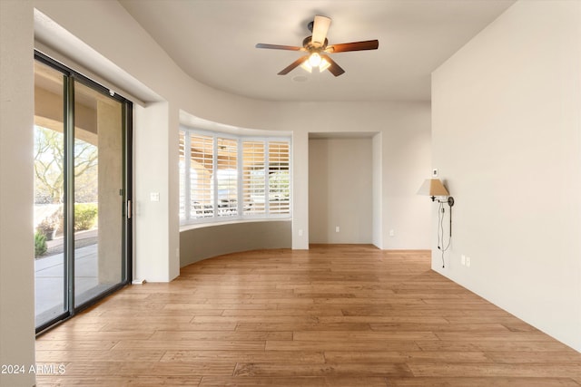 unfurnished room with ceiling fan and light hardwood / wood-style flooring