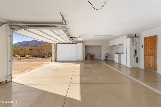 garage with a mountain view and a garage door opener