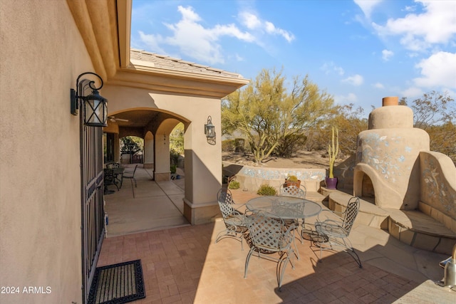 view of patio / terrace with exterior fireplace