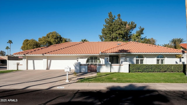 mediterranean / spanish-style house featuring a garage and a front yard