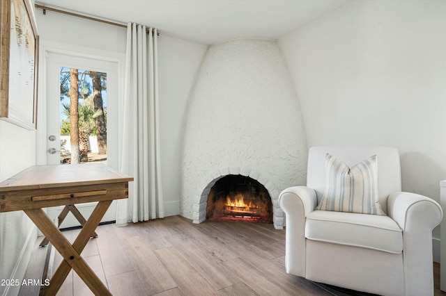 living area with a fireplace and light wood-type flooring