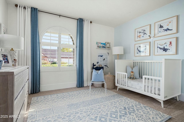 carpeted bedroom featuring a crib