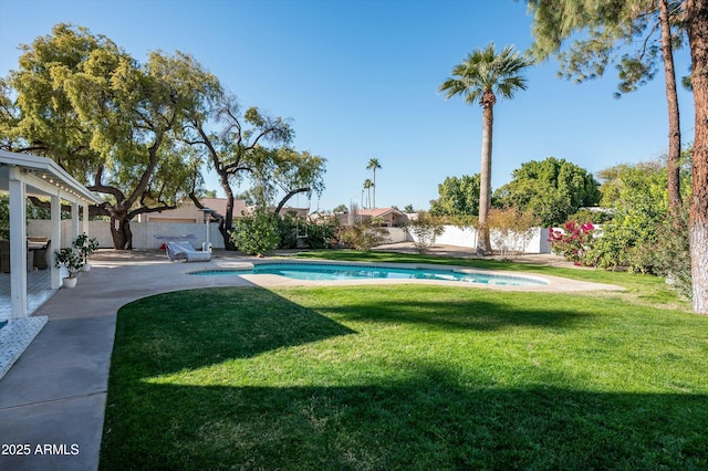 view of yard with a fenced in pool and a patio area